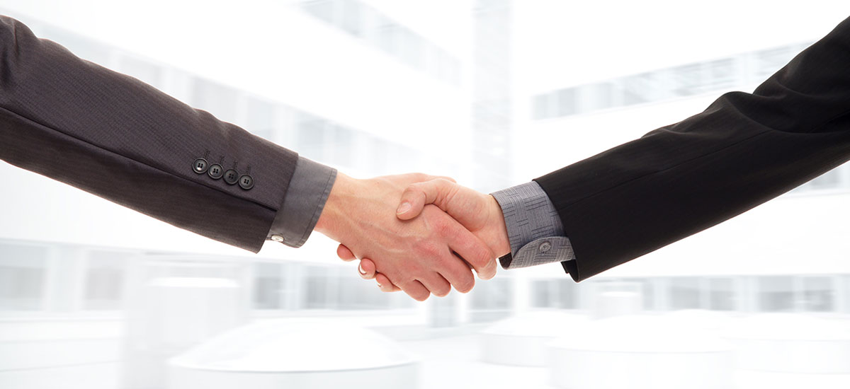 An isolated handshake between two businessmen.