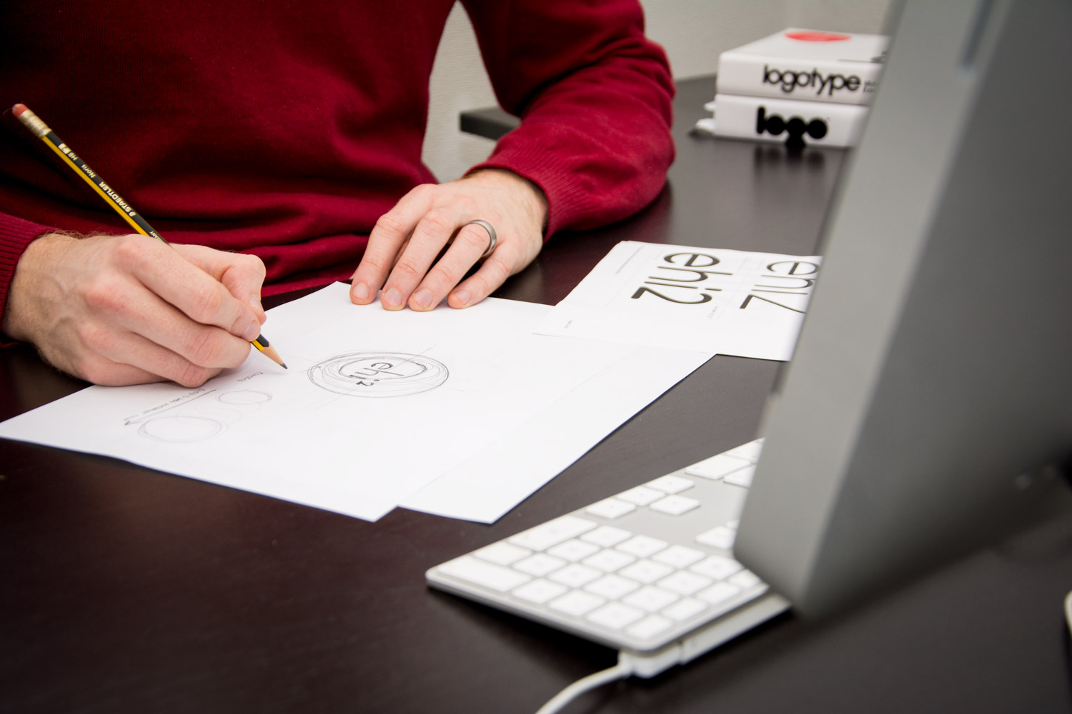 ehi2 logo design by drawn out by designer at desk